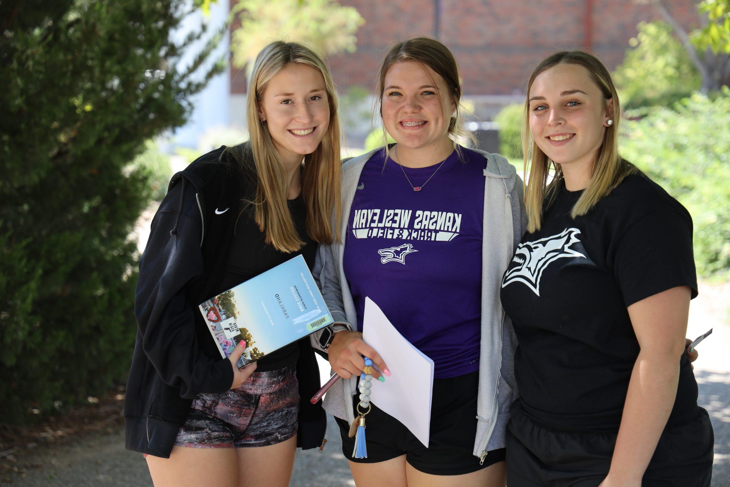 Three female students smiling for photo