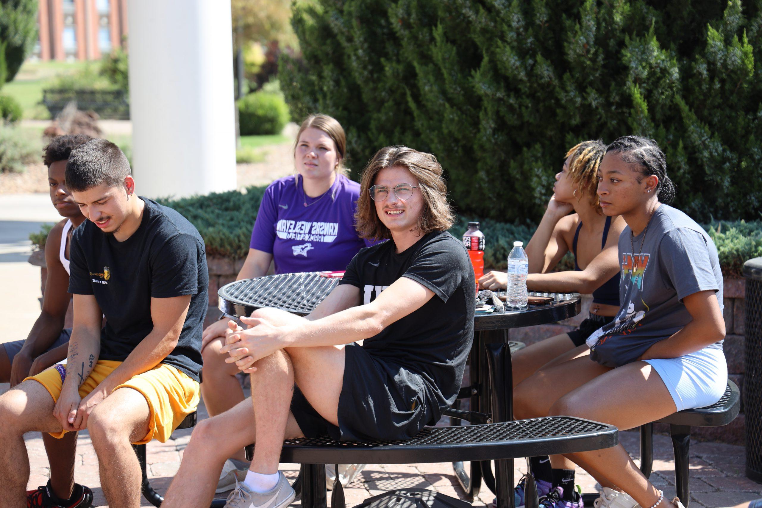 Group of students at table by SAC