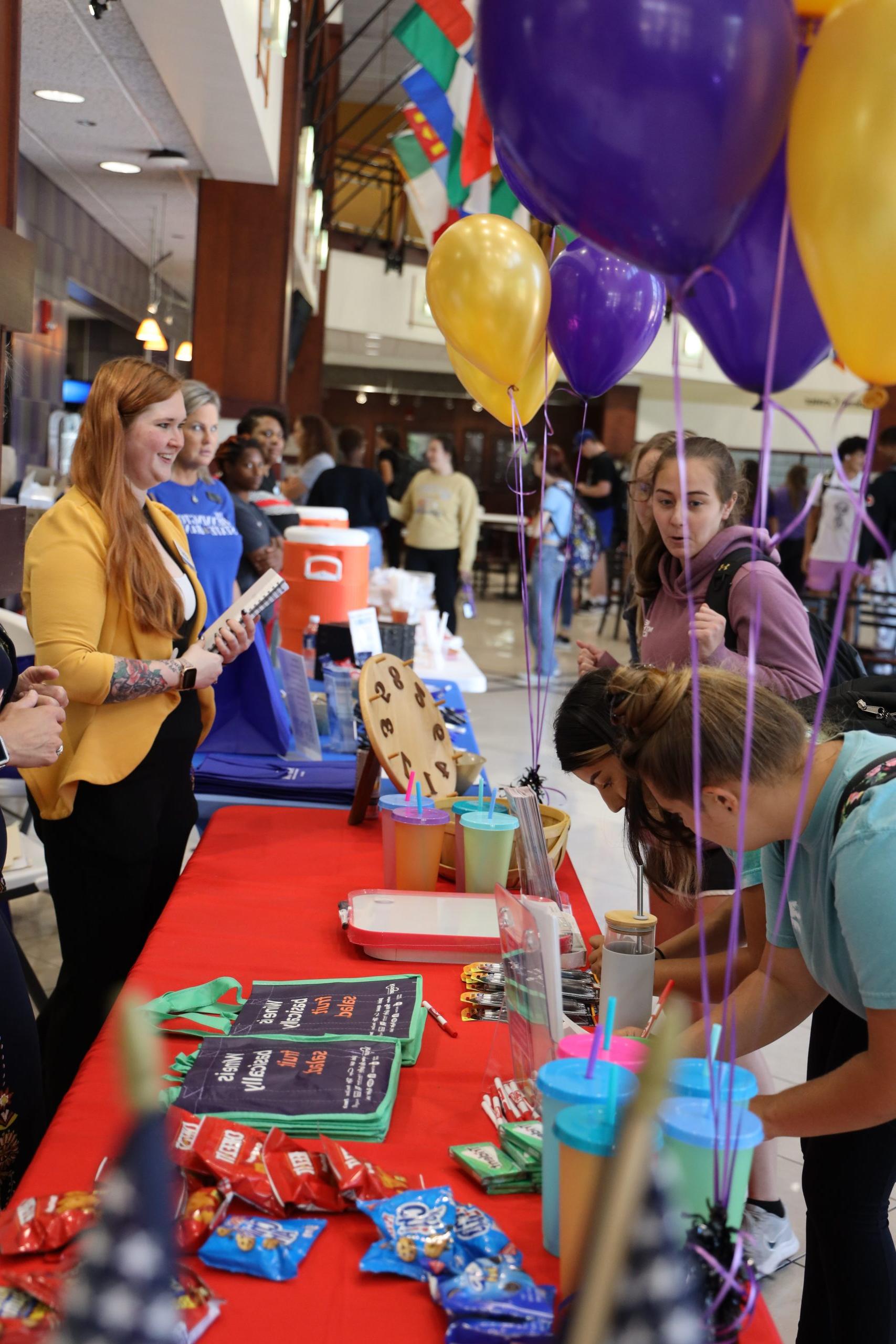 Tables and people interacting at fair