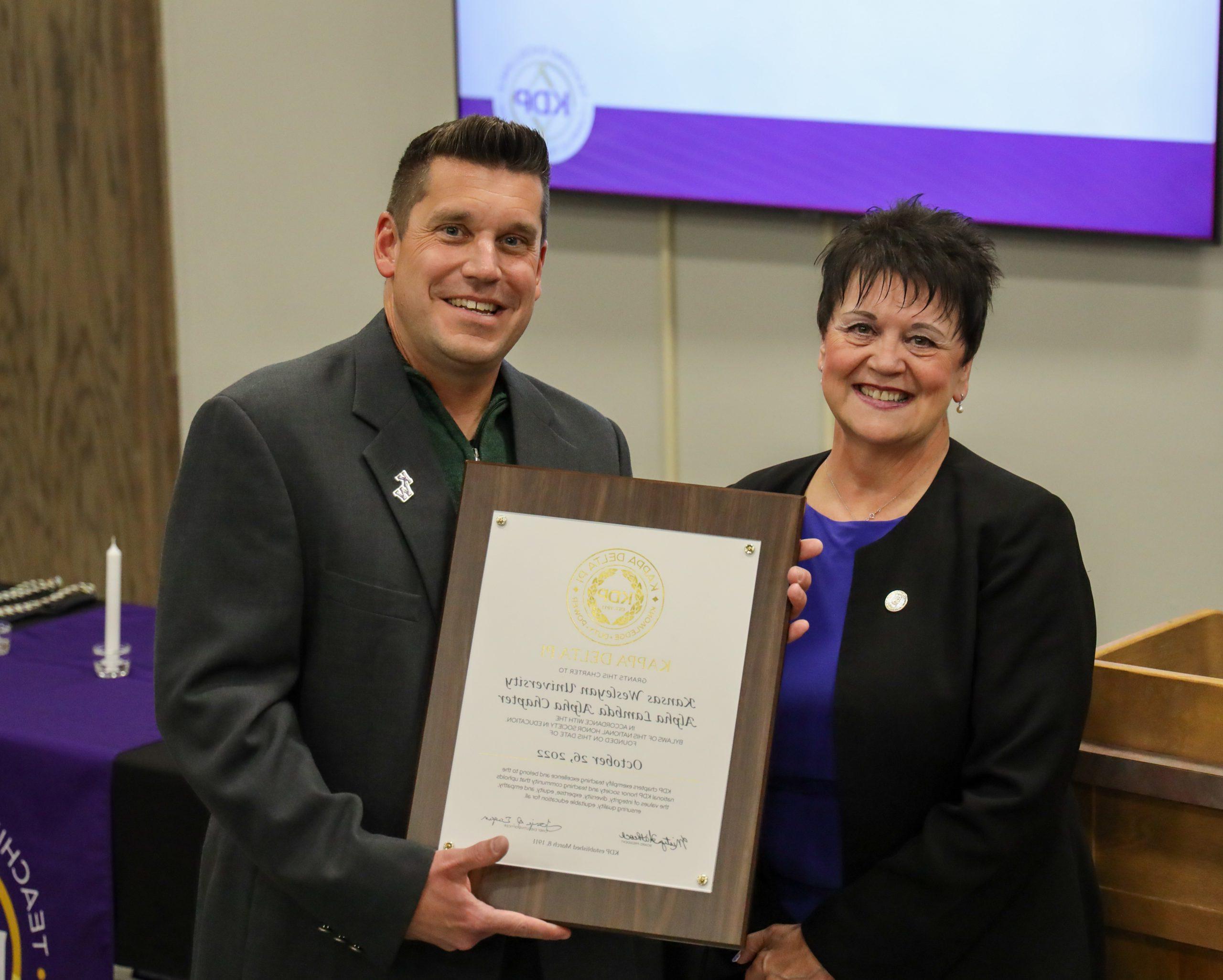 Man holding proclamation regarding education event