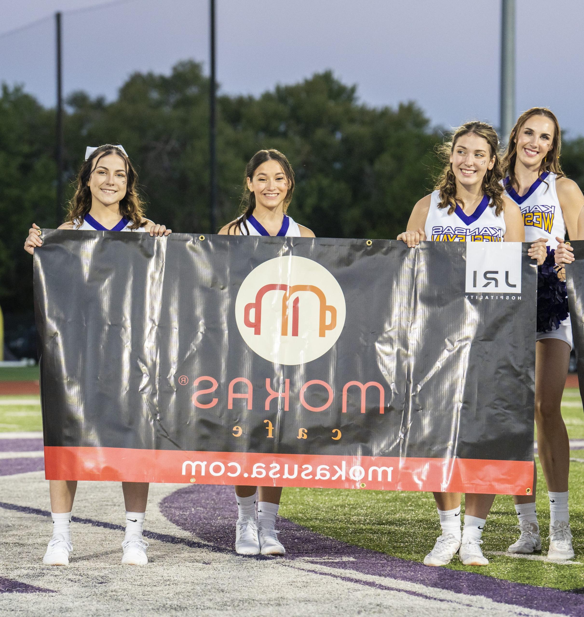 Cheerleaders holding banner